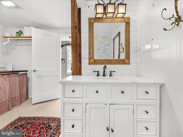 bathroom featuring wooden walls, visible vents, and vanity