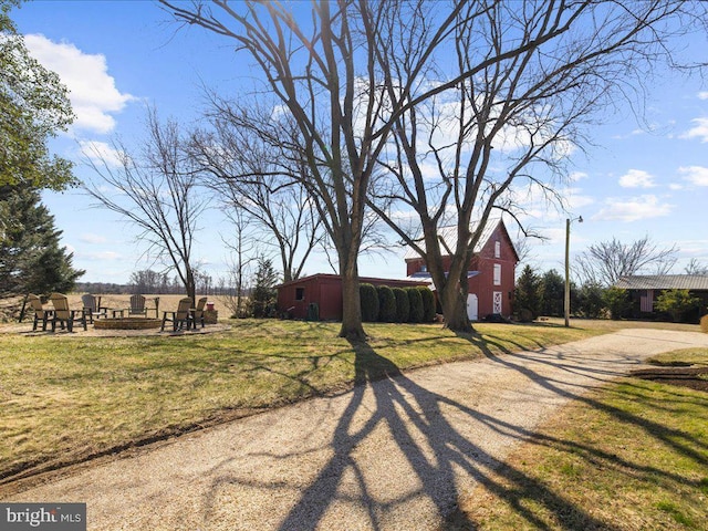 view of yard with an outbuilding and driveway