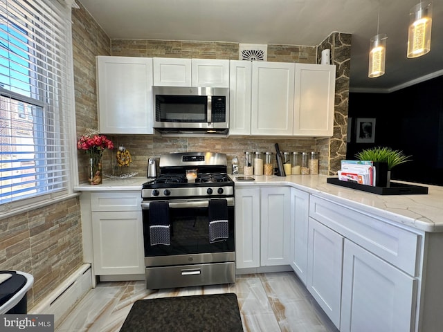 kitchen featuring stainless steel appliances, white cabinets, a peninsula, and tasteful backsplash