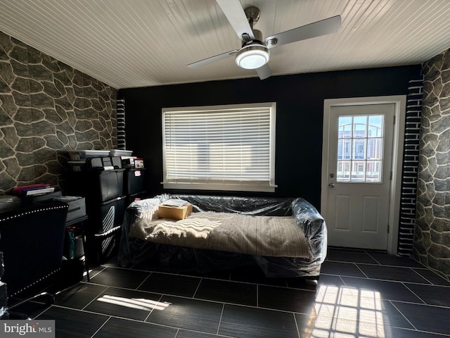 tiled bedroom featuring ceiling fan