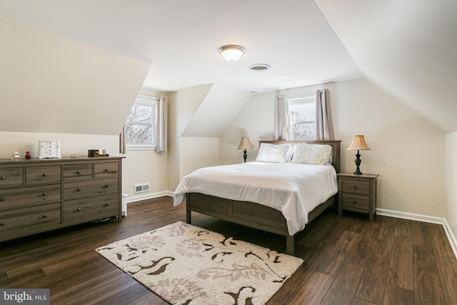 bedroom featuring dark wood finished floors, multiple windows, and visible vents