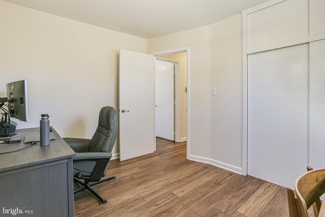 office area featuring baseboards and wood finished floors