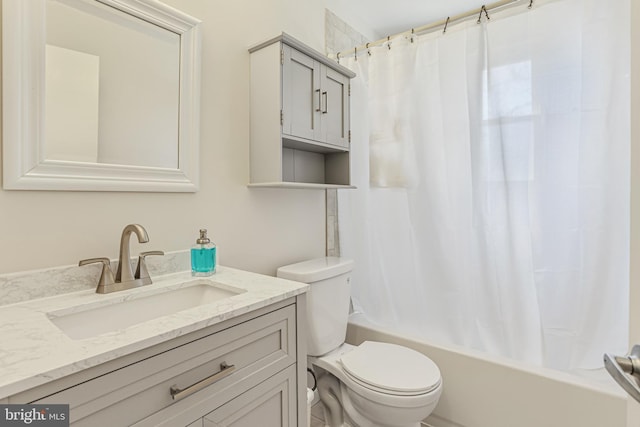 full bathroom with shower / tub combo with curtain, toilet, and vanity