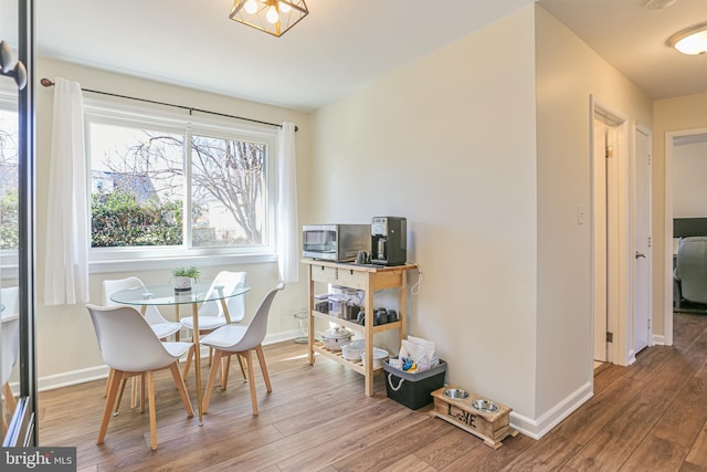 dining area featuring wood finished floors and baseboards