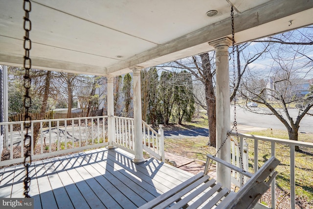 wooden terrace featuring fence