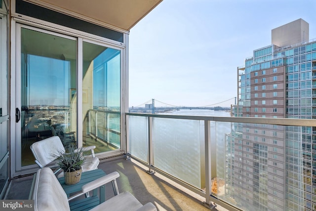 balcony featuring a water view and a view of city