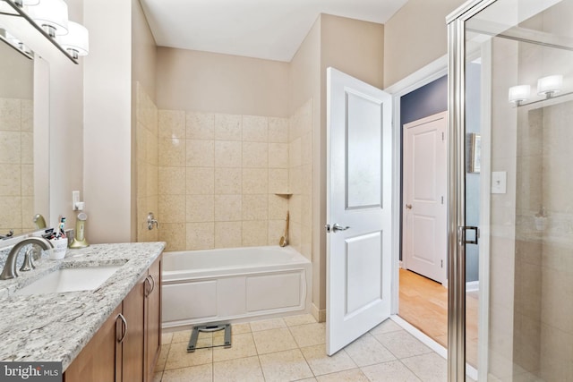 bathroom with a stall shower, vanity, and tile patterned floors