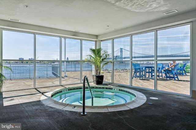 view of pool with an indoor hot tub