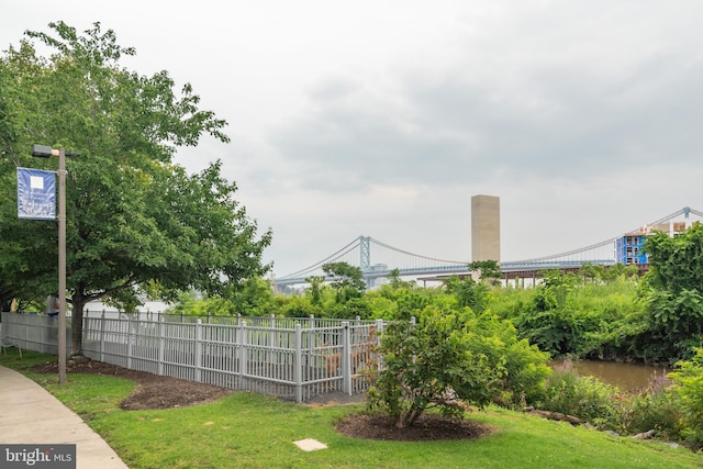 view of yard featuring a water view and fence