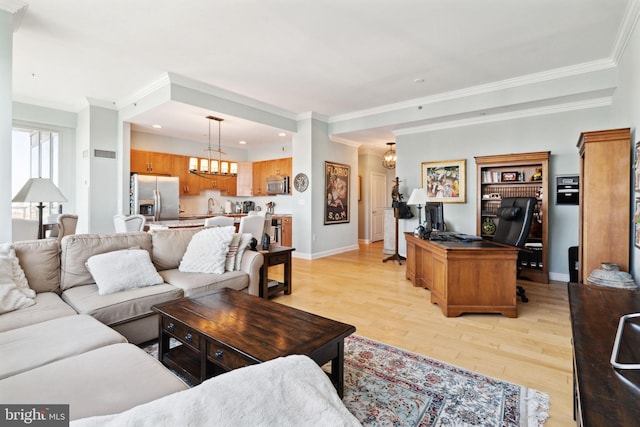 living area featuring baseboards, light wood-style floors, crown molding, and an inviting chandelier