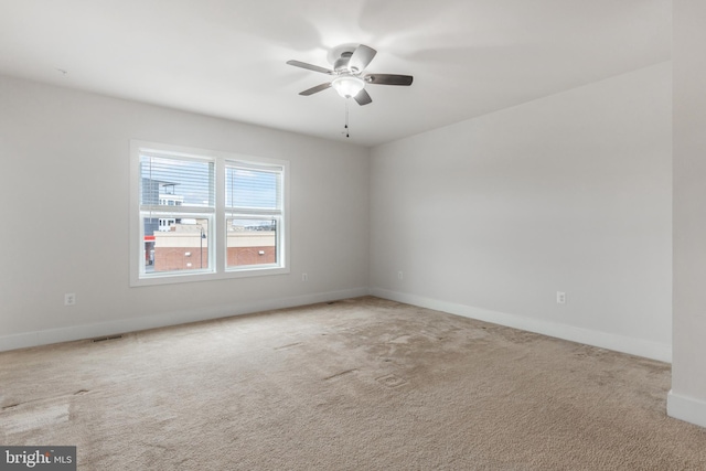 empty room featuring visible vents, baseboards, carpet, and ceiling fan