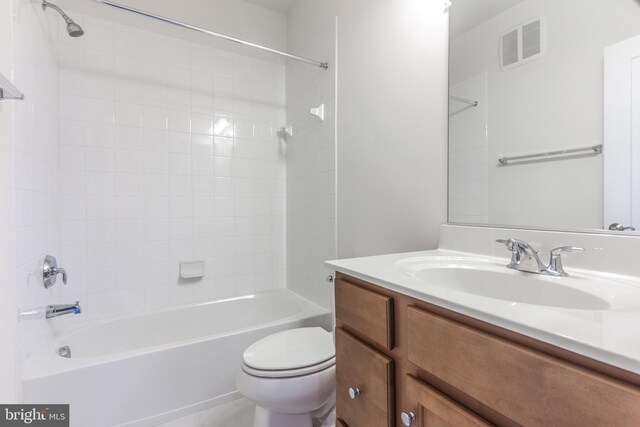 bathroom featuring vanity, toilet, visible vents, and shower / washtub combination