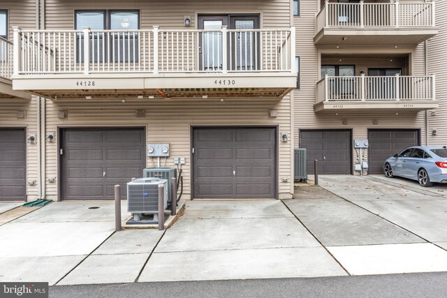 exterior space with a garage, central AC, and driveway