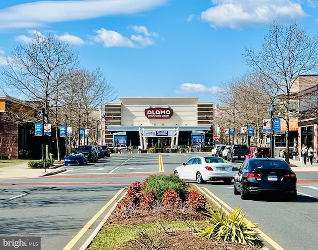 view of road featuring street lights, curbs, and sidewalks