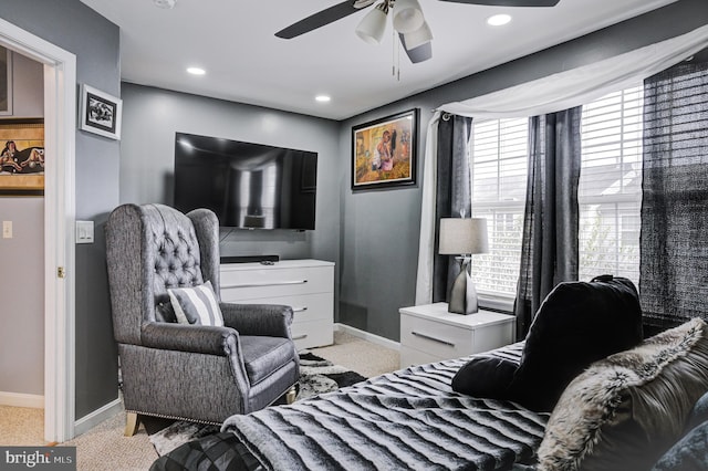 interior space with baseboards, ceiling fan, and carpet flooring