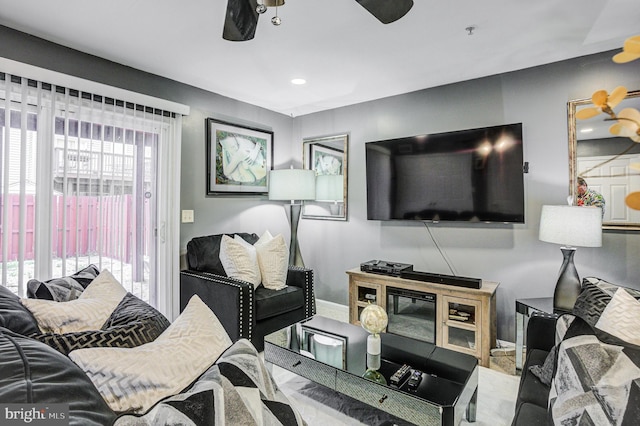 living area with recessed lighting, baseboards, and a ceiling fan