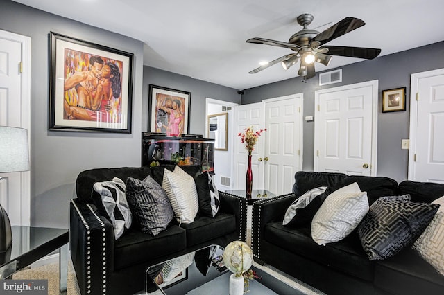 living room with visible vents and a ceiling fan