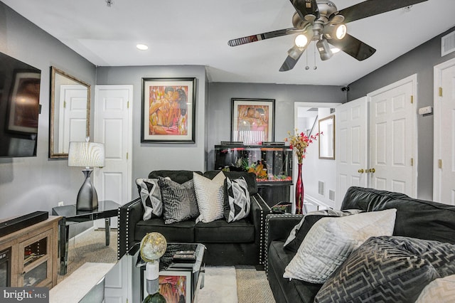 living area with visible vents and ceiling fan