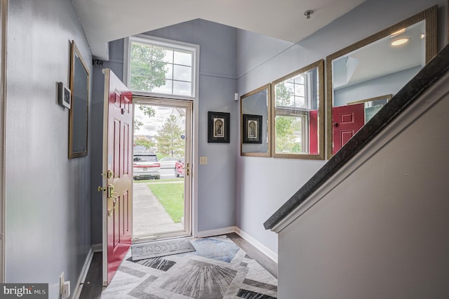 foyer featuring stairs and baseboards