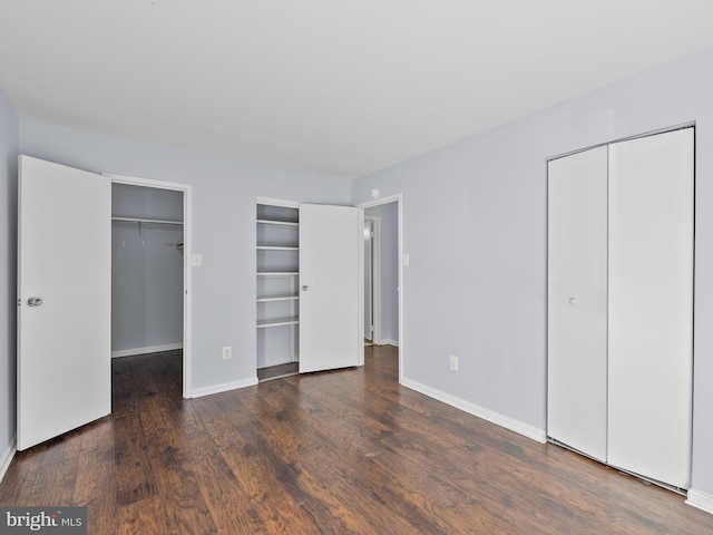 unfurnished bedroom featuring baseboards and wood finished floors