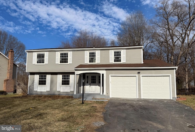 view of front of property featuring aphalt driveway, a porch, a front lawn, and fence