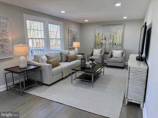 living room featuring recessed lighting, baseboards, and wood finished floors