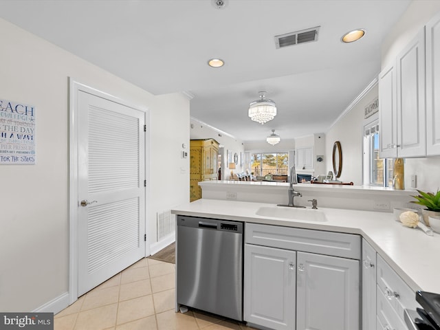 kitchen with visible vents, a peninsula, light countertops, stainless steel dishwasher, and a sink