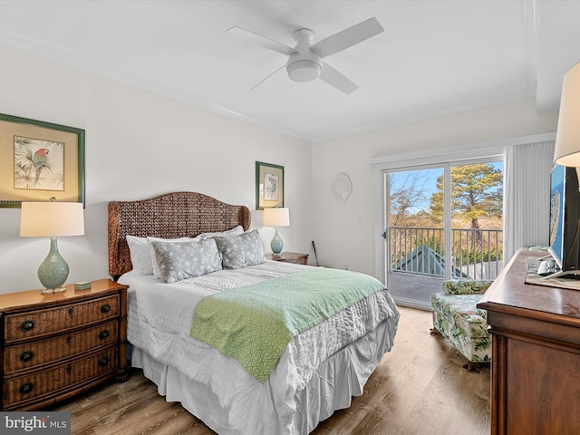 bedroom with ornamental molding, wood finished floors, a ceiling fan, and access to exterior