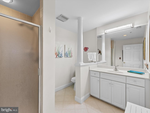 full bathroom with toilet, vanity, a shower stall, baseboards, and tile patterned floors