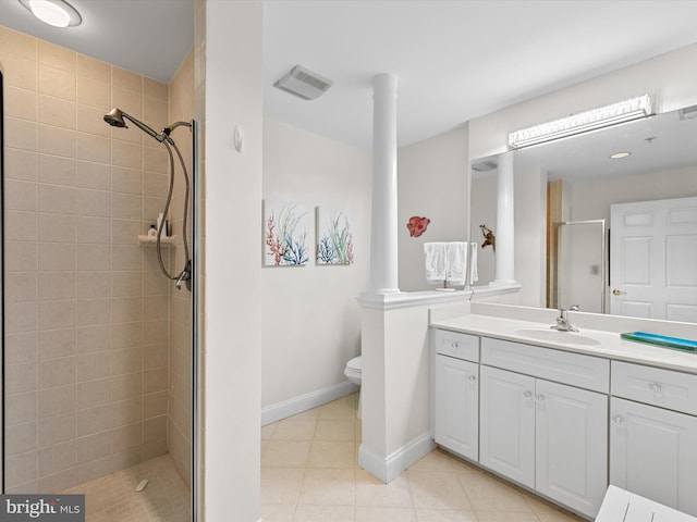 full bath featuring toilet, a shower stall, vanity, tile patterned flooring, and baseboards