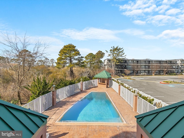 view of swimming pool with a fenced backyard, a fenced in pool, and a patio