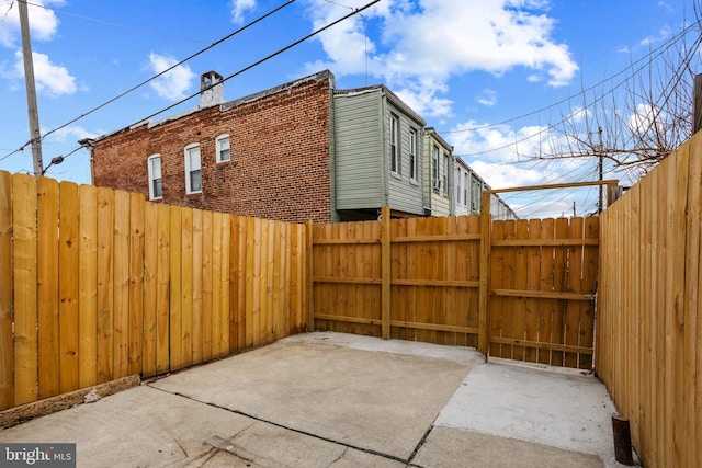 view of patio with a gate and fence