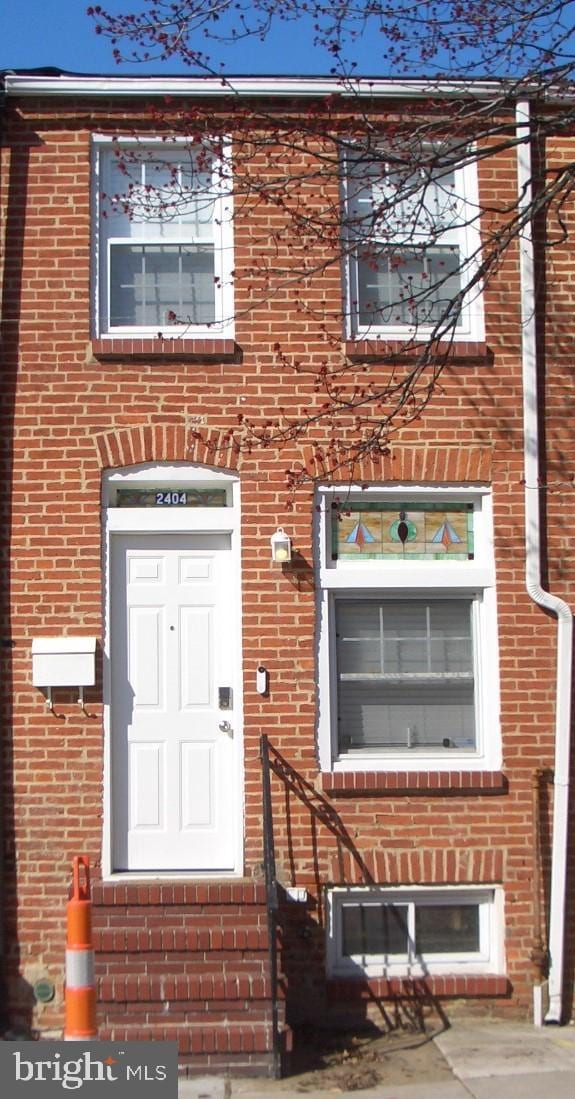 view of front of home featuring brick siding