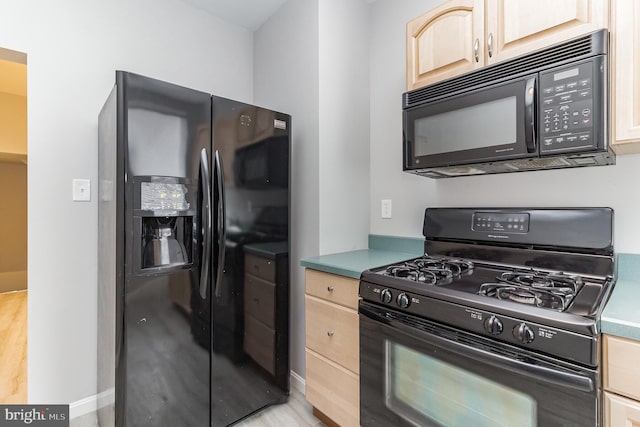 kitchen with black appliances and light brown cabinets