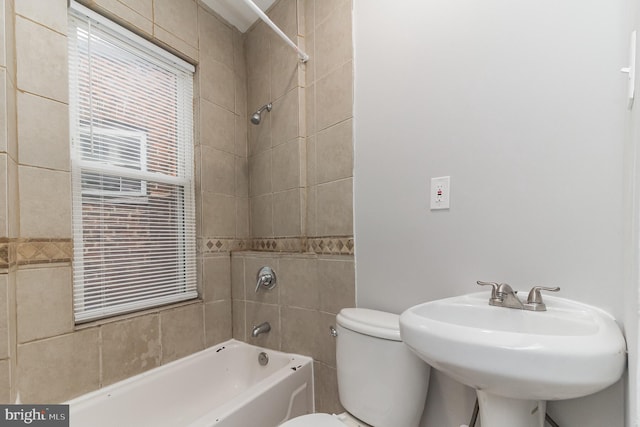 full bath featuring  shower combination, a sink, and toilet