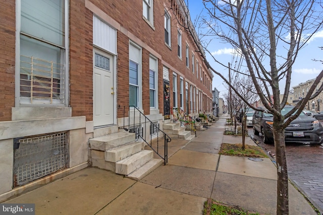 view of building exterior with entry steps and a residential view