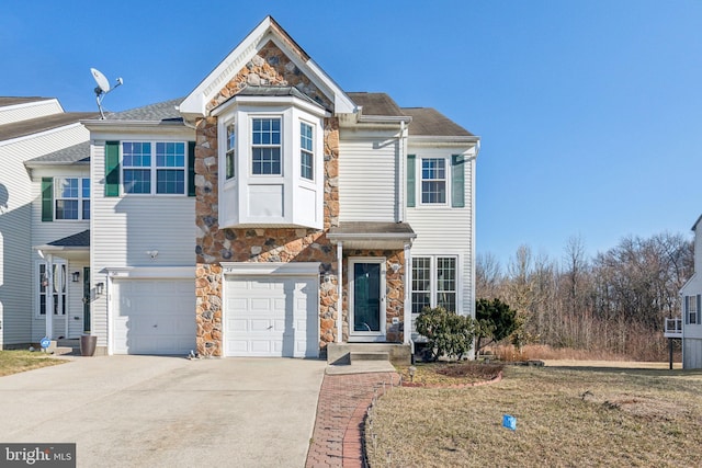 view of front of property with a garage, stone siding, a shingled roof, and driveway