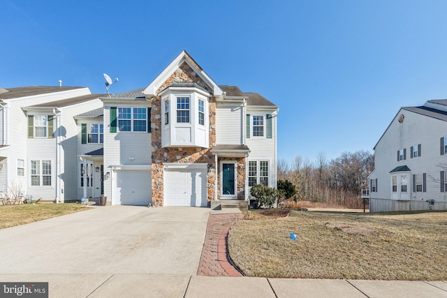 view of front of home with stone siding, driveway, and an attached garage