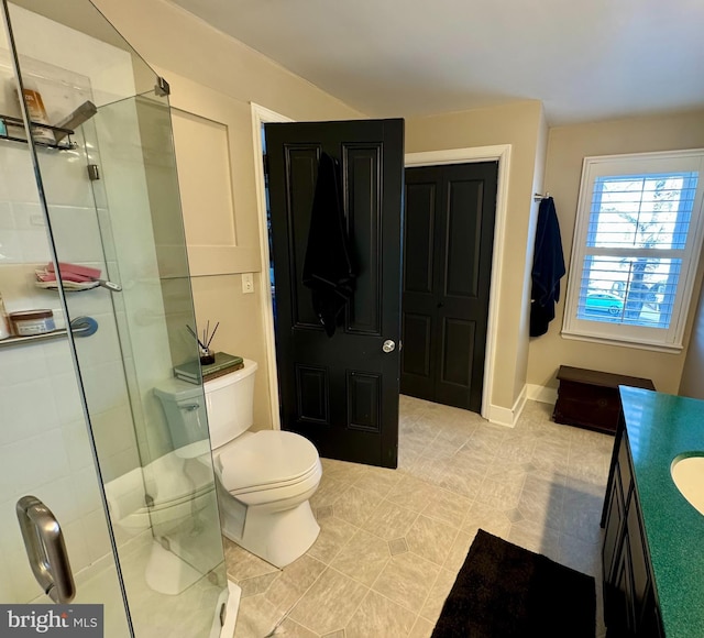 full bathroom with toilet, a stall shower, and vanity