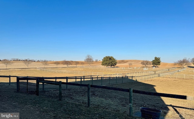 view of yard with a rural view, cooling unit, and fence