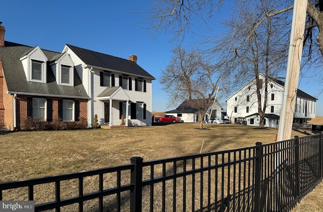 exterior space with a fenced front yard and a residential view