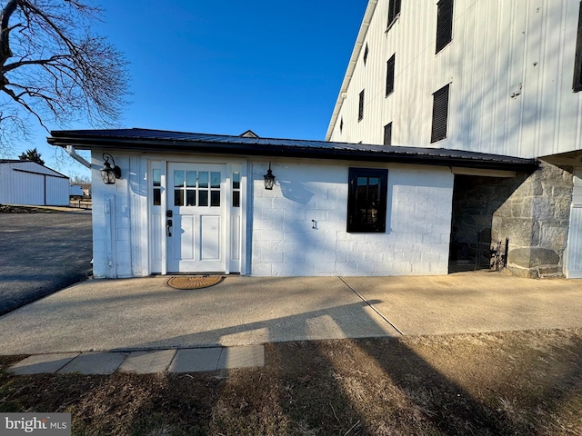 rear view of house with metal roof