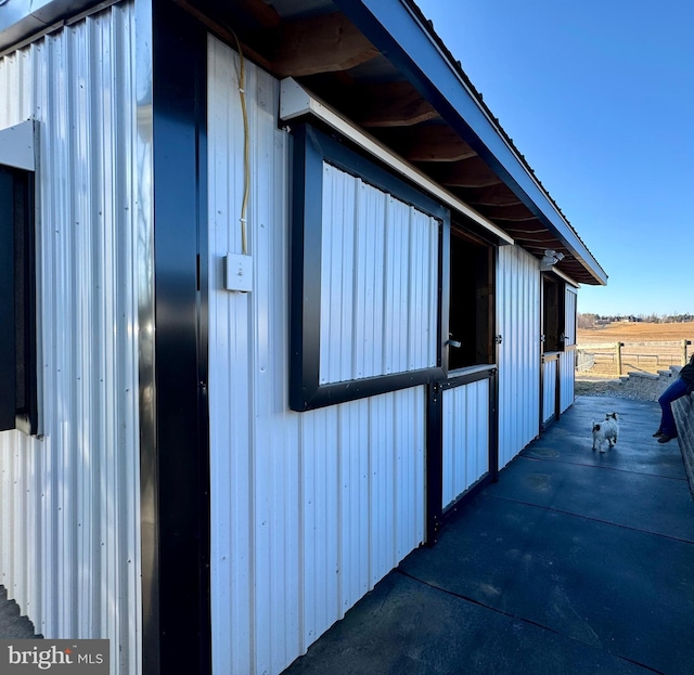 view of side of home featuring an exterior structure and an outdoor structure