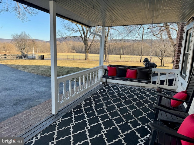 view of patio / terrace with fence and a rural view