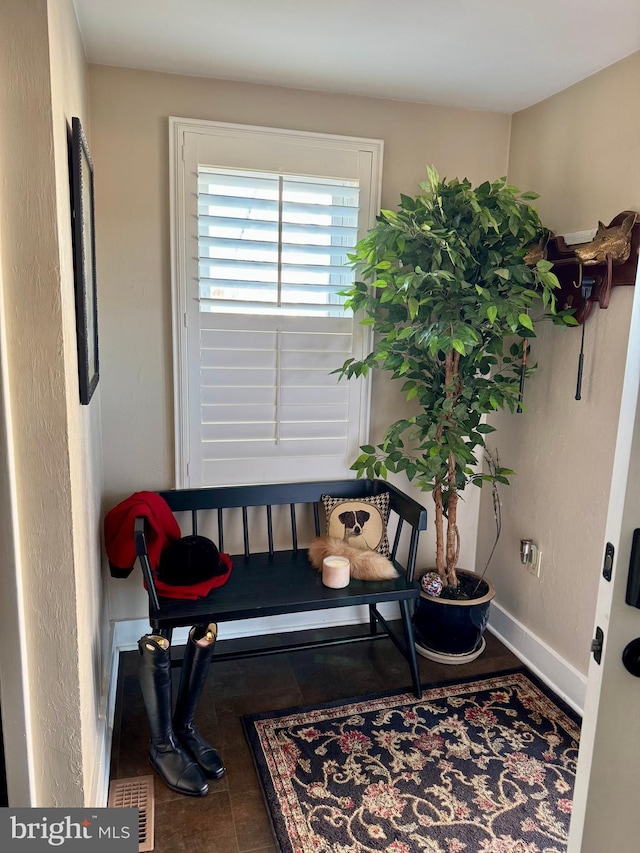 living area featuring baseboards