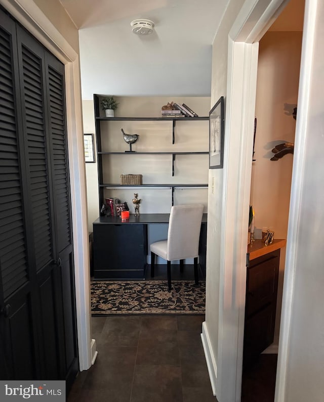 interior space featuring dark tile patterned flooring