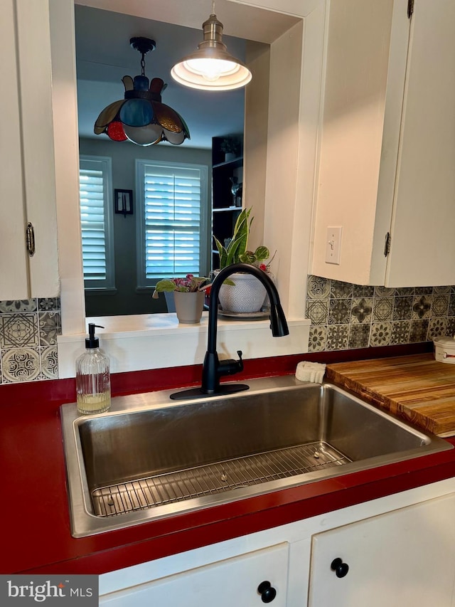 interior space featuring white cabinetry and a sink