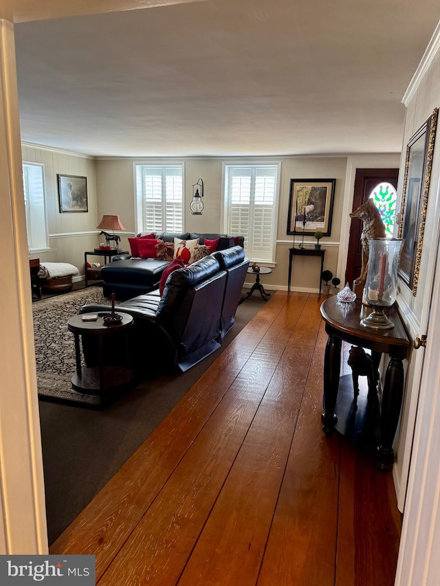 living room featuring hardwood / wood-style flooring and crown molding