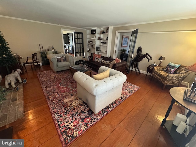 living area with ornamental molding, hardwood / wood-style floors, and baseboards