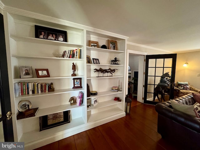 sitting room featuring ornamental molding and dark wood finished floors